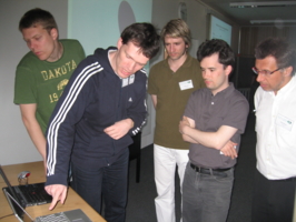 Jan Sieber (Aberdeen, foreground right) demonstrates parameter continuation directly in an experiment without using equations; photograph by Hinke Osinga