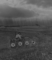 Raking hay with oncoming storm in northern Negev, Israel, 1970