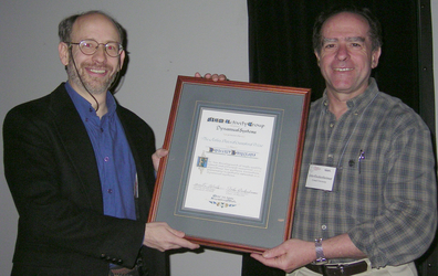 John Guckenheimer hands Dwight Barkley the JD Crawford Prize; photograph by Bernd Krauskopf